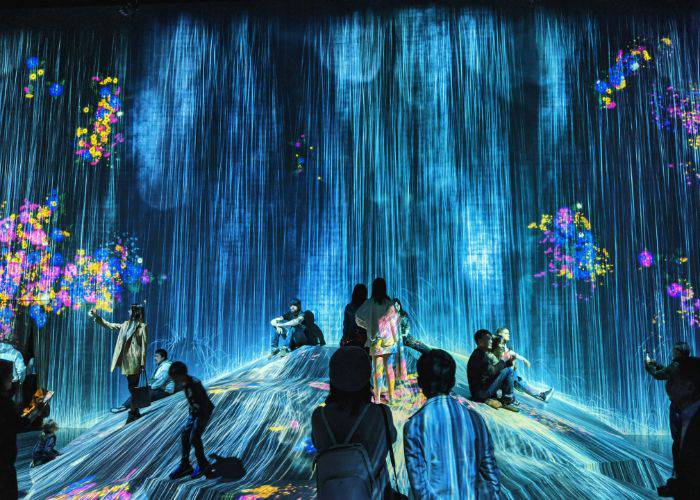 The digital waterfall at teamLab Borderless Museum, where the water flows around guests' feet.